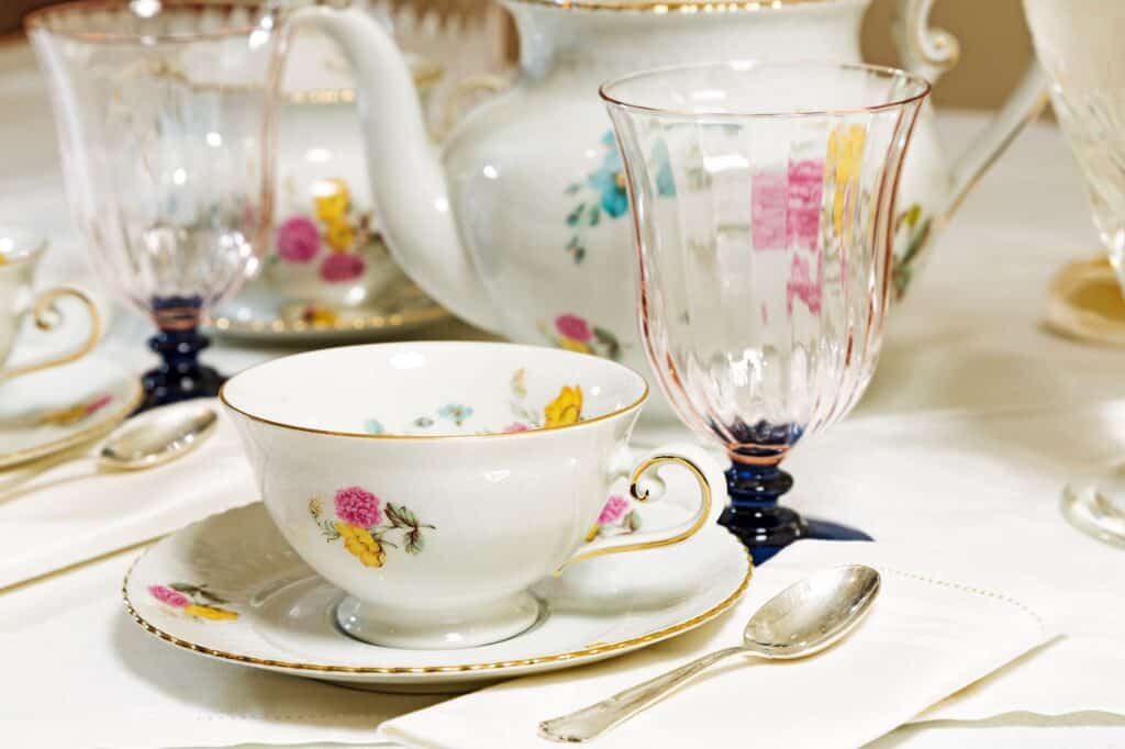 A floral teacup and glasses on the table