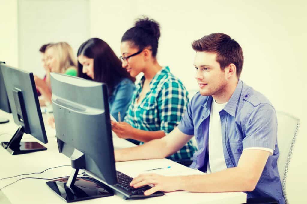 Students in front of their computers inside the classroom