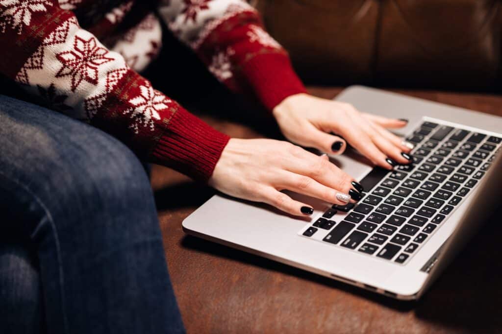 Cropped image of a woman's hands booking a Man and Van online